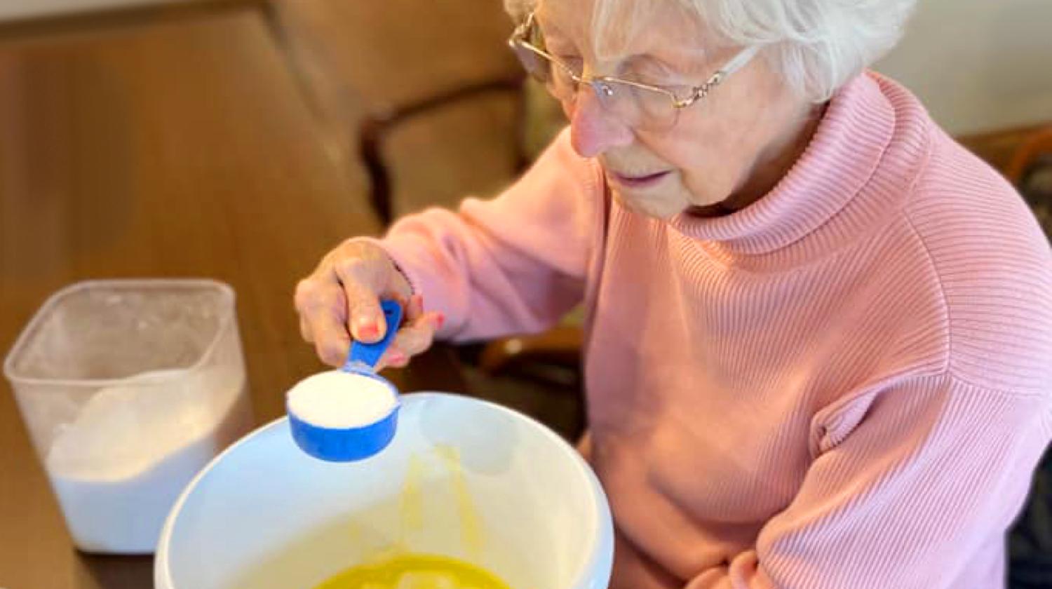 Elderly woman doing baking activity